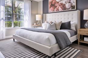 Jupiter apartment for rent - A bedroom with a large bed and a painting on the wall.