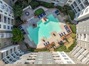 Atlanta apartment for rent - An aerial view of a pool surrounded by buildings and trees.