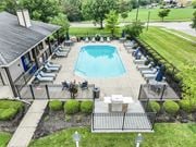 Grove City apartment for rent - A pool surrounded by lounge chairs and a small building.