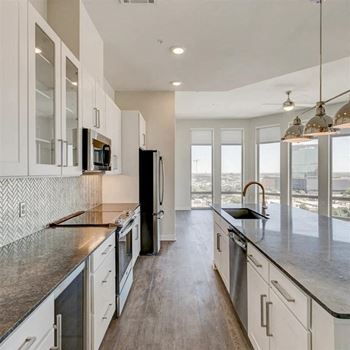 Custom white shaker cabinetry with glass front doors