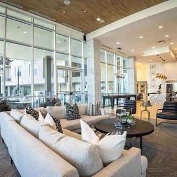 Resident lounge accompanied with a catering kitchen, fireplace, and tv’s