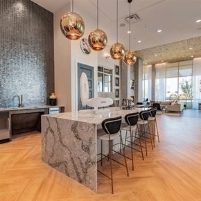 Dallas apartment for rent - resident entertaining kitchen at The Gabriella apartments