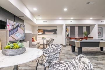 Houston apartment for rent - A modern living room with a pool table and a television.
