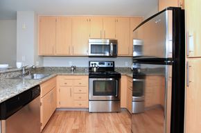 San Jose apartment for rent - A kitchen with wooden cabinets and stainless steel appliances.