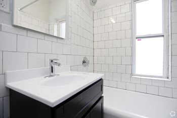 Newly renovated bathrooms with tile surrounds and backsplash