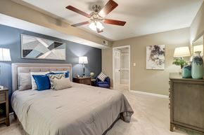 Smyrna apartment for rent - A bedroom with a large bed and a ceiling fan.