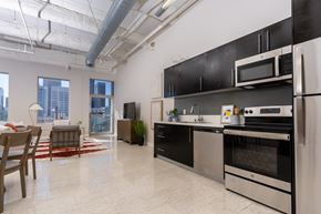 Los Angeles apartment for rent - A kitchen with black cabinets and stainless steel appliances.