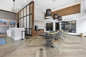 Washington Dc apartment for rent - A modern dining room with a long table and chairs.