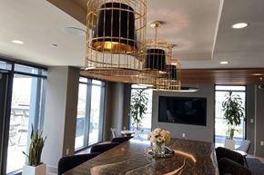 Washington apartment for rent - A modern dining room with a wooden table and a television mounted on the wall.