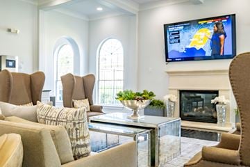 Magnolia apartment for rent - A living room with a television on the wall and a fireplace.