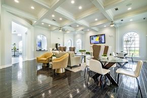 Magnolia apartment for rent - A spacious room with a television, chairs, and a dining table.