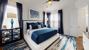 Aubrey apartment for rent - A bedroom with a large bed and a ceiling fan.