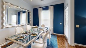 Aubrey apartment for rent - A dining room with a glass table and white chairs.