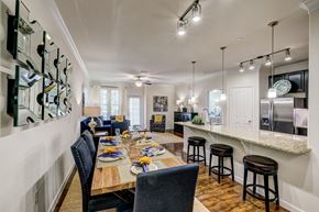 Magnolia apartment for rent - A dining room with a table set for a meal.