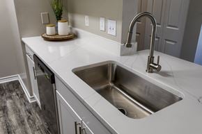 Franklin apartment for rent - A modern kitchen with a stainless steel sink and white countertop.