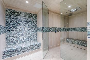 Walk-in showers with built-in bench and glass enclosure