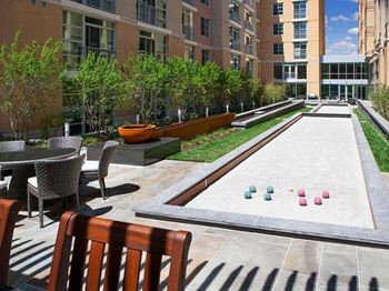 Courtyard with bocce courts, cozy lounges, gas grills and outdoor bar