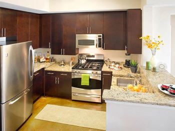 Gourmet kitchens featuring granite countertops, sleek cabinetry and stainless steel ge appliances