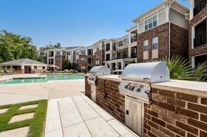Fuquay-Varina apartment for rent - Apartment complex with a pool and BBQ grill.