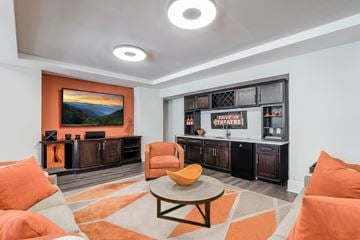 Fuquay-Varina apartment for rent - A living room with orange chairs and a television.