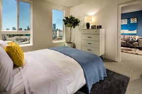 Los Angeles apartment for rent - A bedroom with a large bed and a view of the city.
