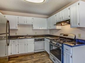 Columbus apartment for rent - A kitchen with white cabinets and a black stove top.