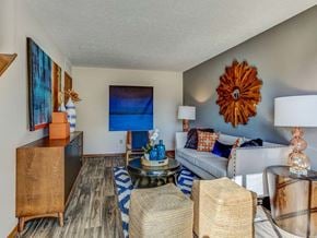 Columbus apartment for rent - A living room with a white couch and a wooden cabinet.
