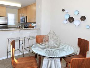 San Jose apartment for rent - a dining area with a table and chairs and a kitchen in the background
