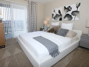 San Jose apartment for rent - a bedroom with a white bed and a large window