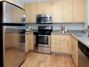 San Jose apartment for rent - a kitchen with stainless steel appliances and wooden cabinets