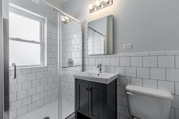 Newly renovated bathrooms with tile surrounds and backsplash