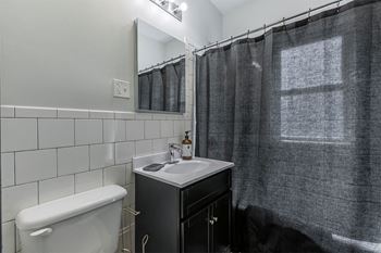 Newly renovated bathrooms with tile surrounds and backsplash