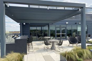 Rooftop terrace boasting a fire pit, pergola lounging area, grill stations. And conversation nooks
