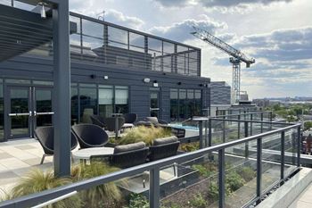 Rooftop terrace boasting a fire pit, pergola lounging area, grill stations. And conversation nooks