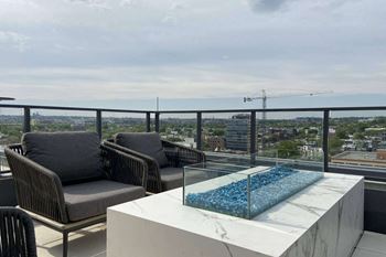 Rooftop terrace boasting a fire pit, pergola lounging area, grill stations. And conversation nooks