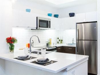 Stainless steel glass top range, dishwasher and double door refrigerator with ice maker