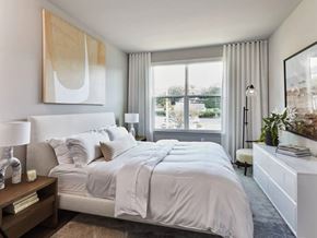 Park Ridge apartment for rent - A bedroom with a large bed and a painting on the wall.