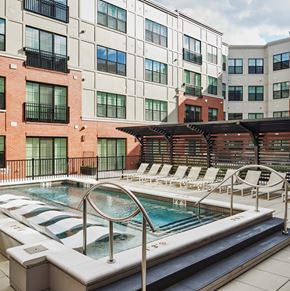 Park Ridge apartment for rent - A pool with a hot tub in front of a building.
