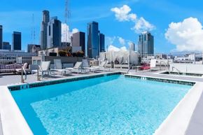 Los Angeles apartment for rent - A swimming pool with a city skyline in the background.
