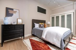 Los Angeles apartment for rent - A bedroom with a bed, dresser, and a rug.