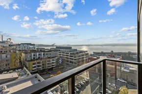 Seattle apartment for rent - A balcony overlooks a cityscape with buildings and a body of water.