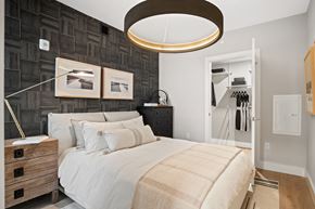Washington apartment for rent - A bedroom with a large bed and a wooden dresser.