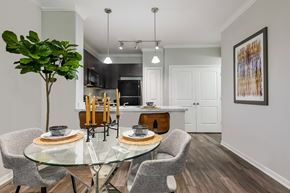 Houston apartment for rent - A modern dining room with a glass table and chairs.