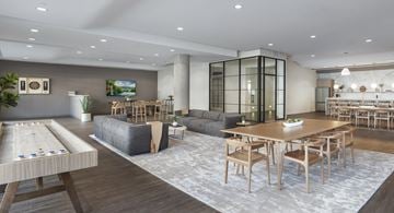 Stamford apartment for rent - A modern living room with a shuffleboard table in the foreground.