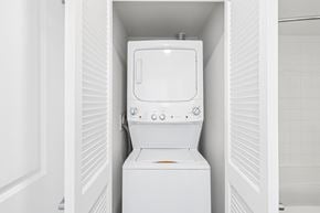 Arlington apartment for rent - A white washing machine is sitting in a small space.