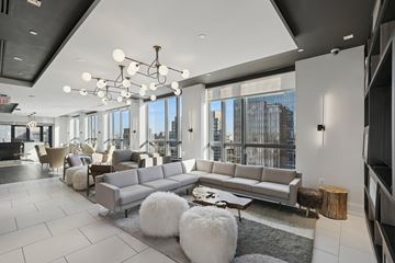 Arlington apartment for rent - A modern living room with a large grey sofa and a coffee table.