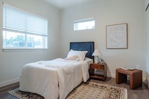 Fort Collins apartment for rent - A bedroom with a large bed and a window with blinds.