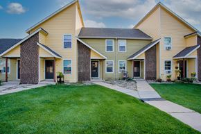 Windsor townhouse for rent - a row of houses with a sidewalk and grass
