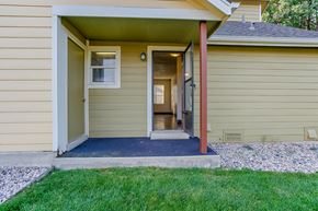Windsor townhouse for rent - the front porch of a yellow house with a porch swing