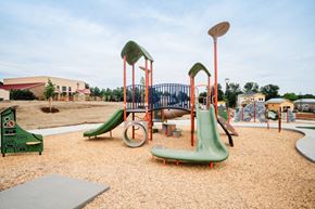 Fort Collins apartment for rent - A playground with a green slide and a red and white slide.